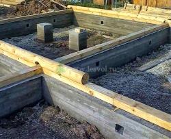 Укладывается первый венец на готовый ленточный фундамент